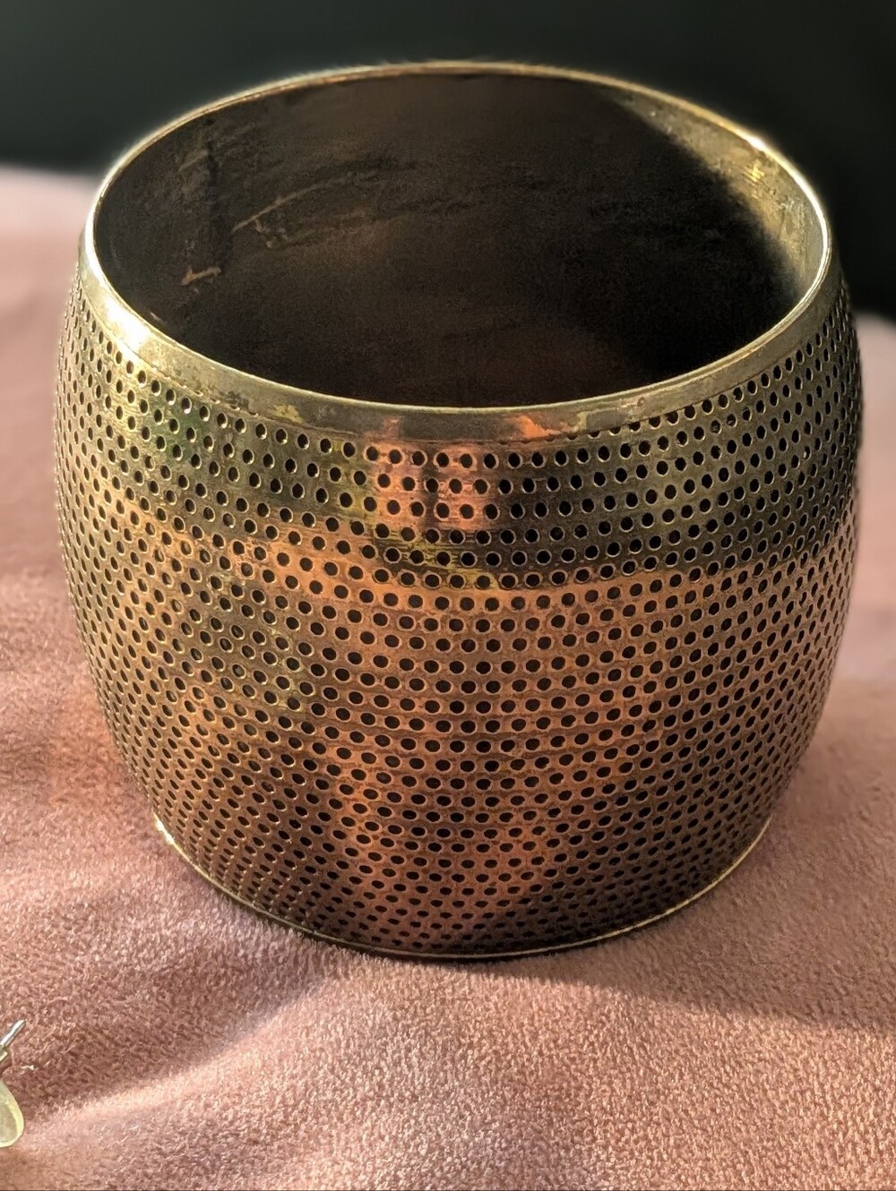 Auslini brass bangle features a perforated, dotted texture. Collectible